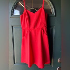 Bright coral dress with scallop pockets and neckline